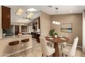 Bright dining room with seating for four and a view into the kitchen and its granite countertops at 926 W Grand Caymen Dr, Gilbert, AZ 85233