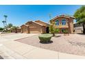 Charming two-story home with a three-car garage, desert landscaping, and a tiled roof at 926 W Grand Caymen Dr, Gilbert, AZ 85233