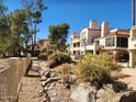 Attractive condo buildings with red tile roofs surrounded by lush, desert landscaping and trees at 10080 E Mountainview Lake Dr # 110, Scottsdale, AZ 85258