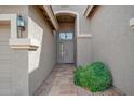 Arched front entryway featuring covered porch and desert landscaping at 1079 S Western Skies Dr, Gilbert, AZ 85296