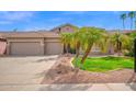 Inviting home featuring a tile roof, a 3 car garage, and desert landscaping at 1079 S Western Skies Dr, Gilbert, AZ 85296