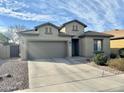 Charming single-story home with a neutral stucco finish, well-kept landscaping, and a spacious two-car garage at 10909 E Sentiero Ave, Mesa, AZ 85212