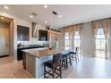 Bright kitchen featuring a large island, stainless steel appliances, modern lighting, and plenty of cabinet space at 12035 W Roy Rogers Rd, Peoria, AZ 85383