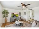 Cozy living room featuring wood floors, a ceiling fan and TV set on console at 1504 W 6Th St, Mesa, AZ 85201