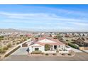 A high aerial view of the front of the house showing solar panels, desert landscaping, and mountain views at 19612 W Georgia Ave, Litchfield Park, AZ 85340