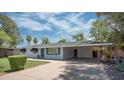 Inviting single-story home showcasing a covered parking area and lush front yard at 2121 S Ventura Dr, Tempe, AZ 85282