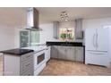 Updated kitchen featuring stainless steel appliances, gray cabinets, and granite countertops at 2121 S Ventura Dr, Tempe, AZ 85282