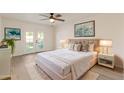 Cozy bedroom with french doors, a ceiling fan, plush carpeting, and ample natural light at 2366 E Shea Blvd, Phoenix, AZ 85028
