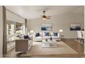 Bright living room with large window, modern furnishings, and neutral color palette at 2366 E Shea Blvd, Phoenix, AZ 85028