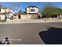 Street view of a well-maintained two-story house with a three-car garage and attractive desert landscaping at 2825 N Villas N Ln, Chandler, AZ 85224