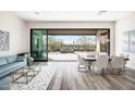 Open-concept living and dining area with large sliding doors to the outdoor patio and desert views at 3045 W Feather Sound Dr, Anthem, AZ 85086