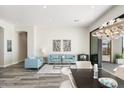 Bright and spacious living area adjacent to dining room with a view to outdoor patio at 3045 W Feather Sound Dr, Anthem, AZ 85086