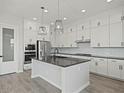 Modern kitchen featuring stainless steel appliances, an island, and white cabinets at 3875 E Appaloosa Rd, Gilbert, AZ 85296