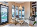 Cozy breakfast nook with built-in bench seating, chandelier and access to the outdoor living space at 42001 N Bridlewood Way, Phoenix, AZ 85086