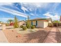 Single-story home with desert landscaping, gravel accents, and mature cacti at 4401 E Walatowa St, Phoenix, AZ 85044