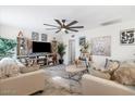 Bright and airy living room with stylish decor, modern furniture and a large ceiling fan at 5014 W Gardenia Ave, Glendale, AZ 85301