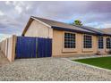 Home exterior featuring a privacy gate, gravel landscaping, and ample windows at 502 N 110Th St, Mesa, AZ 85207