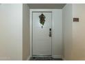 Close up of a front door featuring unit number and festive wreath hanging, creating a welcoming entrance at 535 W Thomas Rd # 211, Phoenix, AZ 85013
