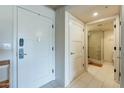 Bright hallway view with a bathroom entry, showcasing clean lines, tile flooring, and modern doors at 535 W Thomas Rd # 211, Phoenix, AZ 85013