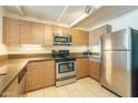 Well-equipped kitchen featuring sleek countertops, stainless steel appliances, and modern wood-grain cabinetry at 535 W Thomas Rd # 211, Phoenix, AZ 85013