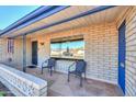 Inviting covered front porch features decorative brickwork and outdoor seating at 6319 E Duncan St, Mesa, AZ 85205