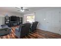 Cozy living room with hardwood floors, a fireplace, and ample natural light at 6319 E Duncan St, Mesa, AZ 85205
