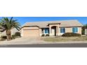 Charming home featuring desert landscaping, a spacious driveway, and a two-car garage at 9318 E El Paso St, Mesa, AZ 85207