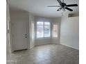 A bright and open living room has shuttered windows and neutral decor at 9318 E El Paso St, Mesa, AZ 85207
