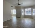 Open-concept living area featuring archways, neutral walls, and tiled floors at 9318 E El Paso St, Mesa, AZ 85207