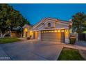 Lovely single-story home showcasing a three-car garage, and manicured front yard at 10431 N 55Th Pl, Paradise Valley, AZ 85253