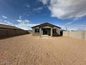 View of the spacious backyard with cinder block fence and desert landscaping at 15773 W Hackamore Dr, Surprise, AZ 85387
