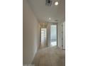 Hallway with tile flooring, recessed lighting, and white walls leading to a bright, airy living space at 15773 W Hackamore Dr, Surprise, AZ 85387