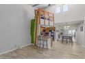 Open living space with a loft area, a unique surfboard accent, and an open floorplan connecting the living and dining areas at 16402 N 31St St # 228, Phoenix, AZ 85032
