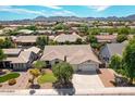 Beautiful aerial shot of single-Gathering home in a quiet suburban neighborhood with mountain views at 20329 E Bronco Dr, Queen Creek, AZ 85142