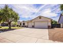 Spacious single-story home with a wide driveway and a well-maintained front yard at 20329 E Bronco Dr, Queen Creek, AZ 85142