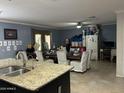 Open-concept dining room features abundant seating and a view of the large kitchen area at 216 N 88Th St, Mesa, AZ 85207