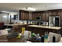An open kitchen features stainless steel appliances, granite countertops, and generous cabinet space, perfect for cooking at 216 N 88Th St, Mesa, AZ 85207