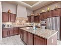 Gourmet kitchen featuring granite countertops, stainless steel appliances, and custom cabinetry at 30056 N 129Th Ave, Peoria, AZ 85383