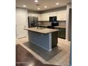 Spacious kitchen with stainless steel appliances and a kitchen island at 32974 N Sandstone Dr, San Tan Valley, AZ 85143