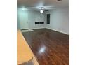 Well-lit living room with laminated floors, white door, and window at 32974 N Sandstone Dr, San Tan Valley, AZ 85143