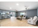 Open-concept living room featuring light wood floors, recessed lighting, and comfortable seating at 3429 W Aire Libre Ave, Phoenix, AZ 85053