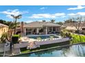 Inviting backyard with pool, patio, and canal view, perfect for outdoor entertaining at 4862 S Jojoba Way, Chandler, AZ 85248