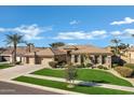 Beautiful single-story home with a well-manicured lawn and desert landscaping at 4862 S Jojoba Way, Chandler, AZ 85248