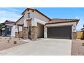 Inviting single-story house with a spacious driveway and stone-accented entryway at 550 E Aurora Dr, San Tan Valley, AZ 85140