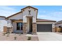 A cozy single-story home featuring stacked stone columns and a well-maintained front yard at 550 E Aurora Dr, San Tan Valley, AZ 85140