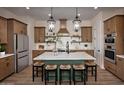 Beautiful kitchen with a large island, pendant lighting, ample cabinet space, and modern appliances at 550 E Aurora Dr, San Tan Valley, AZ 85140