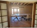 Dining room with tiled floors and chandelier, seen through doors at 7617 E Thunderbird Rd, Scottsdale, AZ 85260