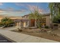 Elegant stucco home with a three-car garage and attractive desert landscaping at 11036 E Evans Rd, Scottsdale, AZ 85255