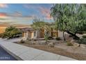 Stunning stucco home with a three-car garage and desert landscaping at 11036 E Evans Rd, Scottsdale, AZ 85255