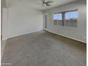 Spacious living room featuring neutral paint, carpeted floors, and an open concept layout at 12164 S 184Th Ave, Goodyear, AZ 85338